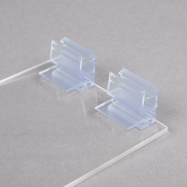 Clear plastic hinged lids for a Cal-Mil condiment holder on a white surface.