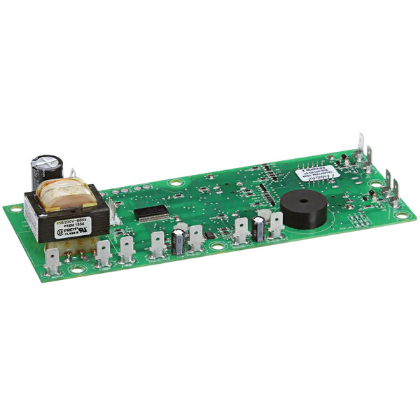 A green circuit board with a black circle and many small electronic components.