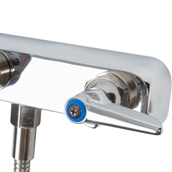 A T&S chrome wall mount faucet with blue handles and an 8" swing nozzle.