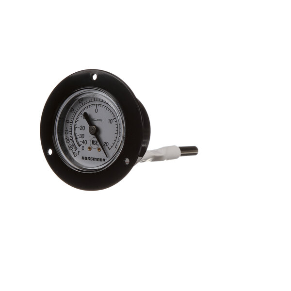 A close-up of a black and white Hussmann temperature control gauge.