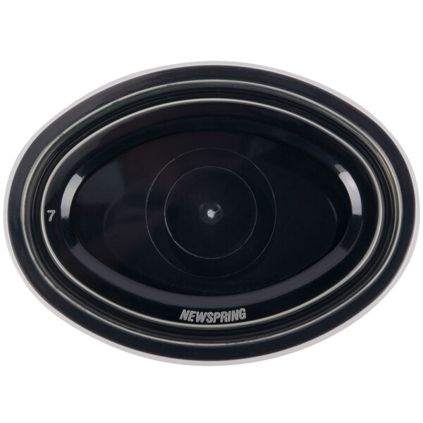 A black oval Newspring souffle cup with a clear lid.