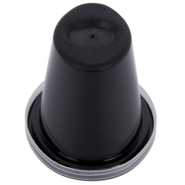 A black Newspring oval souffle cup with a clear lid.
