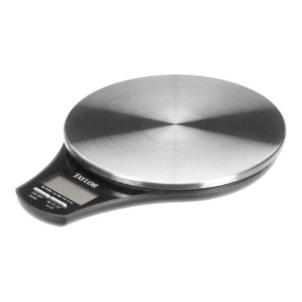 A Multiplex digital scale with a stainless steel cover on a counter.