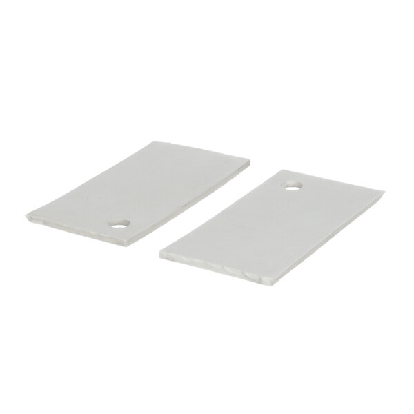 Two white plastic rectangular plates with holes in them.