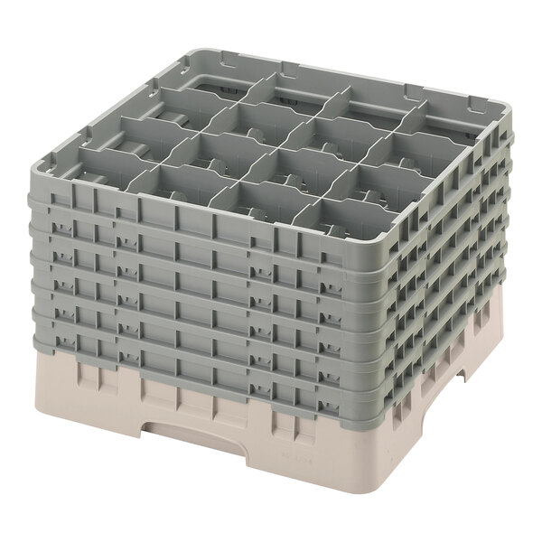 A beige plastic Cambro glass rack with 16 compartments and 6 extenders.