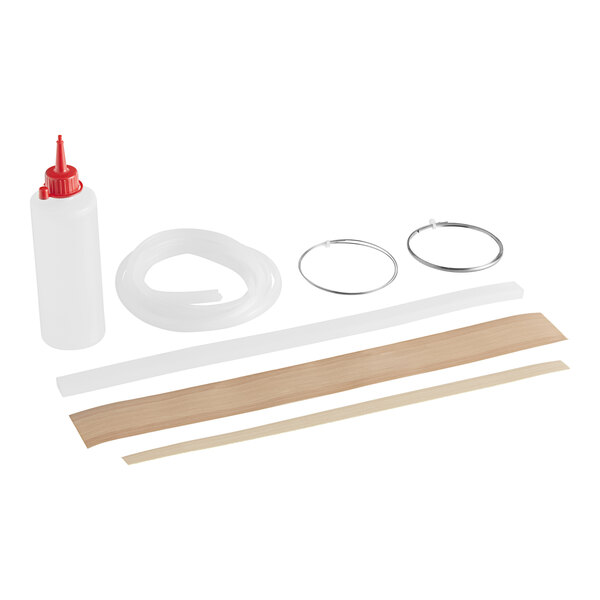 A Vollrath refill kit with a white tube, glue bottle, and white plastic container.