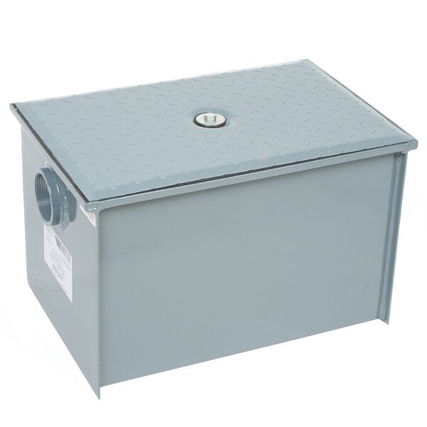 A grey metal Watts grease trap box with a lid on top.