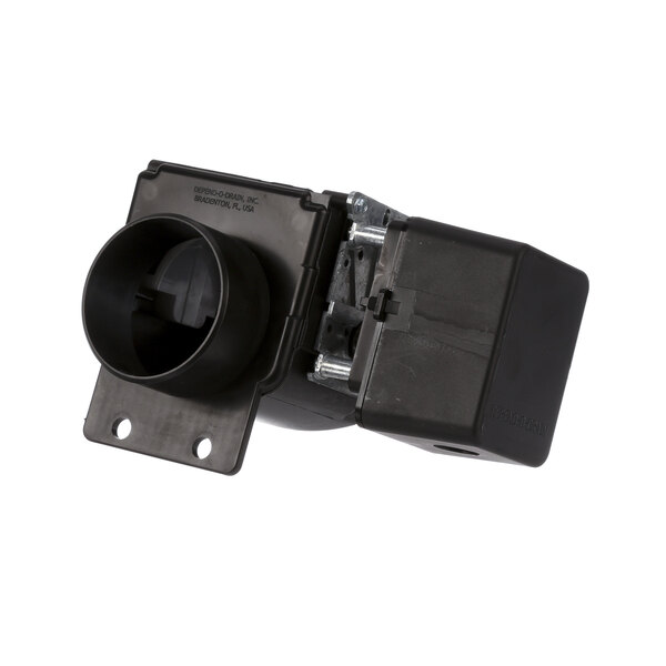 A black plastic Milnor drain valve with a round hole and cover.