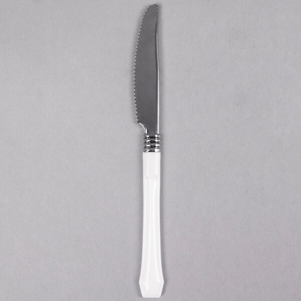 A WNA Comet Reflections Duet heavy weight plastic knife with a white handle and silver blade.