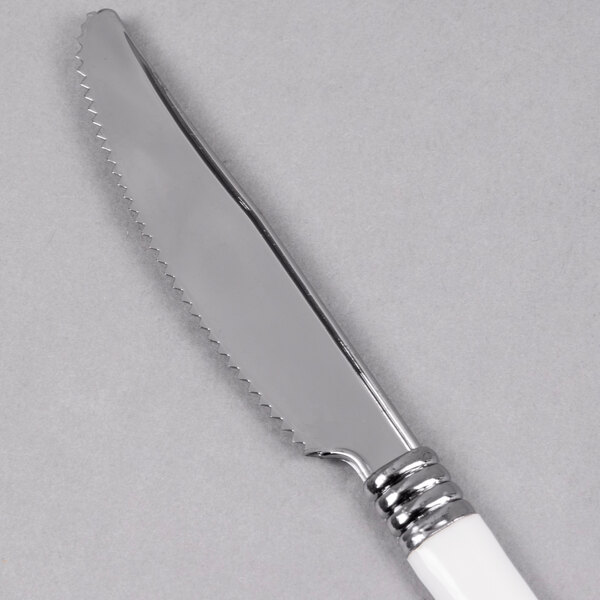 A silver knife with a white handle.