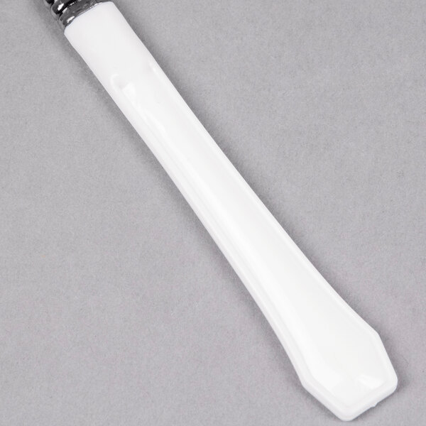 A white plastic knife with a silver tip and white handle.