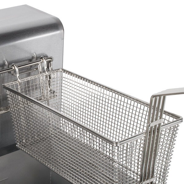 A stainless steel basket with a wire handle inside a Dean electric floor fryer.