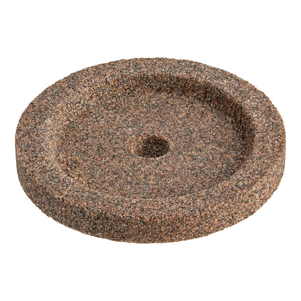 A Hobart truing wheel with a round hole in a stone surface.