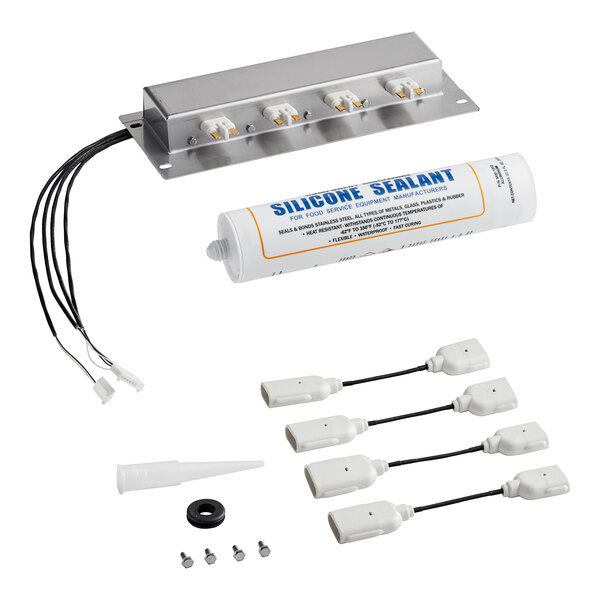 A white box with a silver rectangular object and white plugs, connectors and silicone sealant.