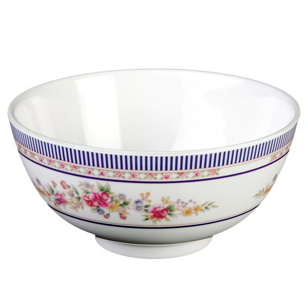 A white bowl with blue stripes and flowers on it.