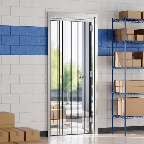 A mesh strip door insect barrier and bug curtain installed in a doorway within a storage or warehouse setting.