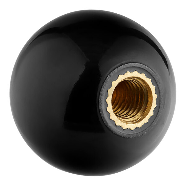 A black knob with a gold nut on it.