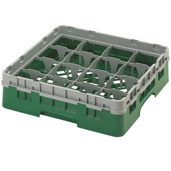 A green and grey plastic Cambro glass rack with 16 compartments and an extender.