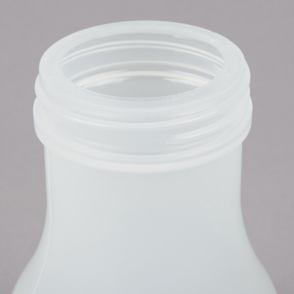 A Tablecraft polypropylene syrup dispenser with a brown lid.