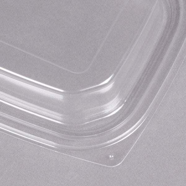 A Dart clear plastic rectangular container with a clear snap-on dome lid.