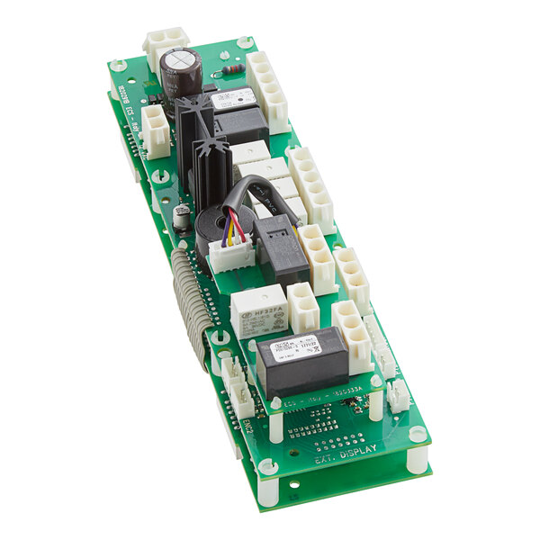 a green circuit board with many wires and wires