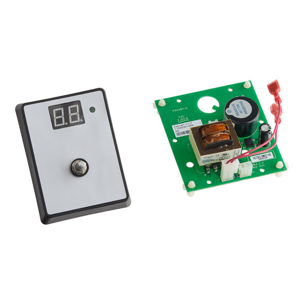 A close-up of a green US Range timer circuit board.