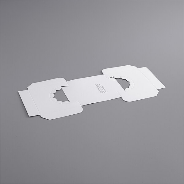 A white rectangular box insert with holes.