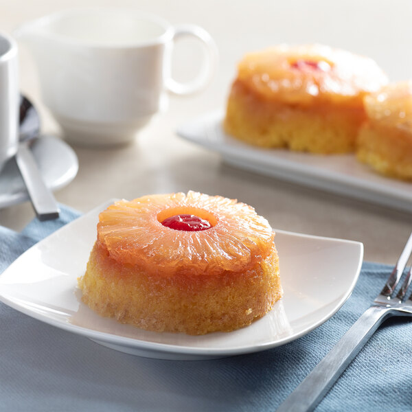 A plate of pineapple upside down cake with sliced pineapple rings on top.