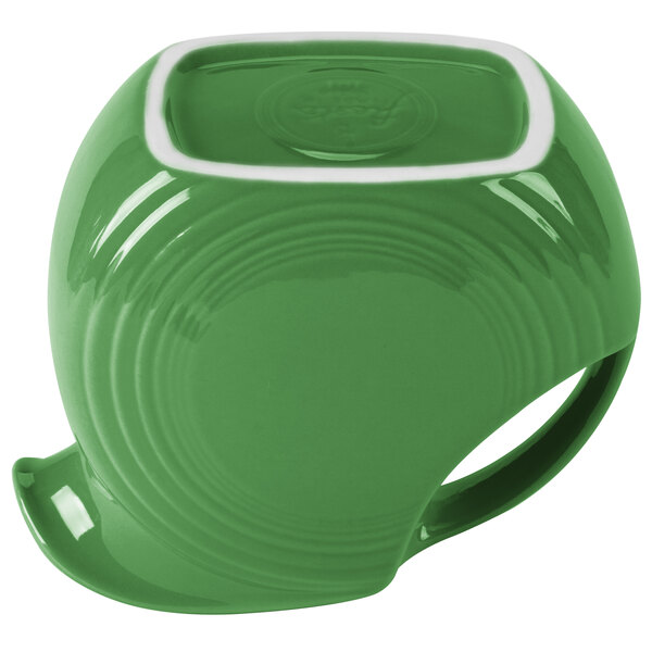 A green pitcher with a white circle in the middle.