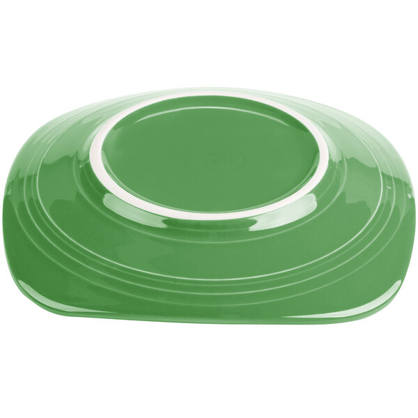 A green Fiesta luncheon plate with a white rim.