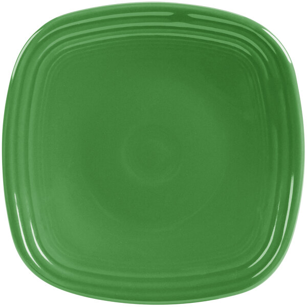 A close up of a green square Fiesta salad plate with a white circle in the middle.