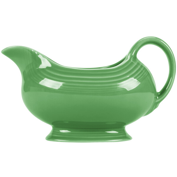 A green ceramic Fiesta gravy boat with handles.