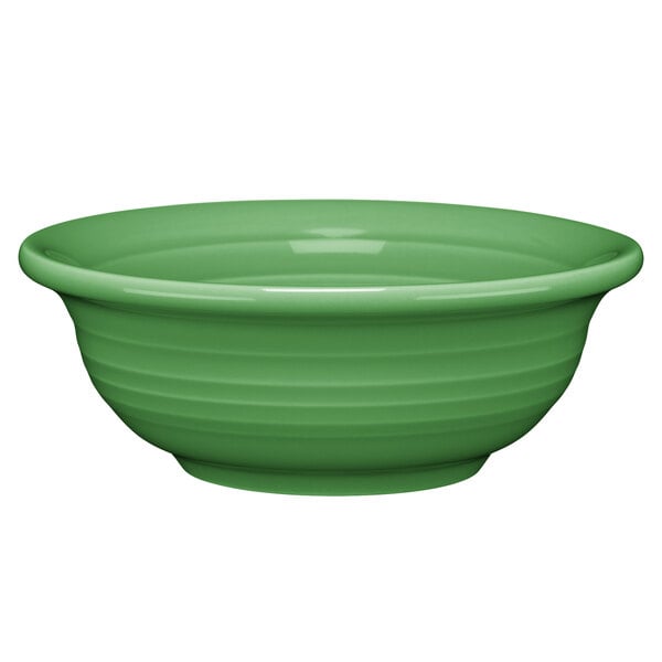 A green Fiesta china bowl with a curved surface.