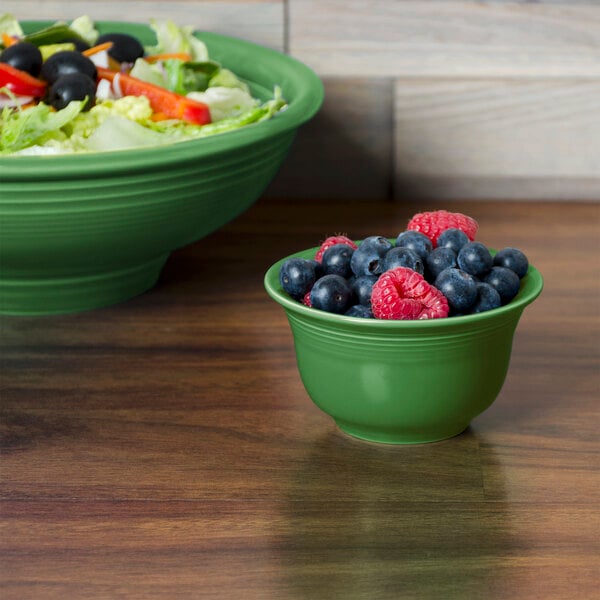 A bowl of salad with blueberries and raspberries.