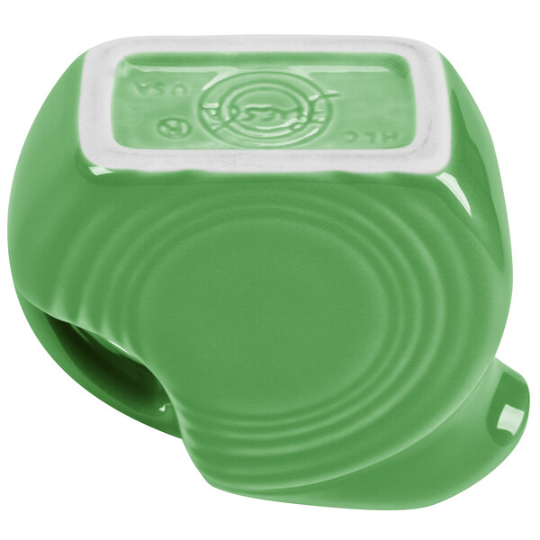 A green Fiesta mini disc creamer pitcher with a white border.