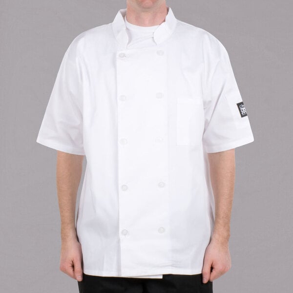 A man wearing a white Chef Revival short sleeve chef coat.