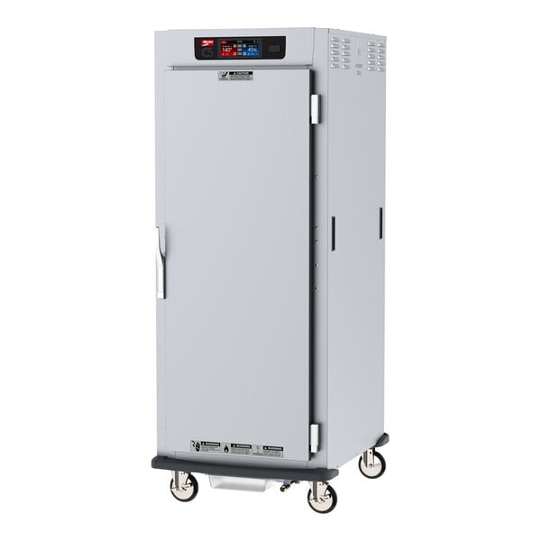 A Metro C5 9 Series heated holding and proofing cabinet with solid doors on wheels.