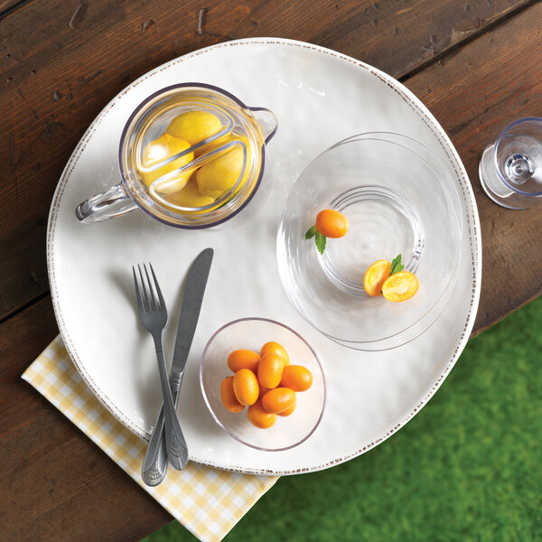 a glass bowl with fruit on it