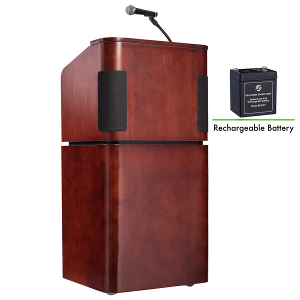 A wooden podium with a microphone and battery.