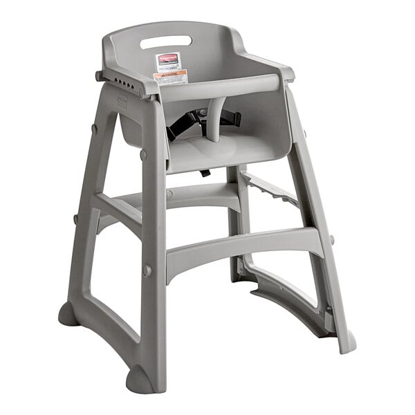 A gray plastic restaurant high chair without wheels.