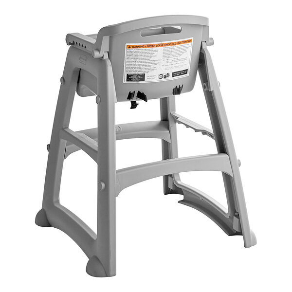 A gray plastic restaurant high chair without wheels.