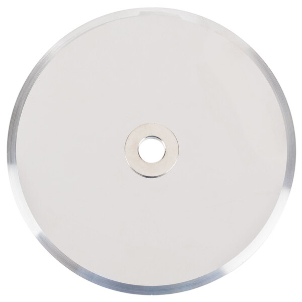 A circular silver metal disc with a hole in the middle.