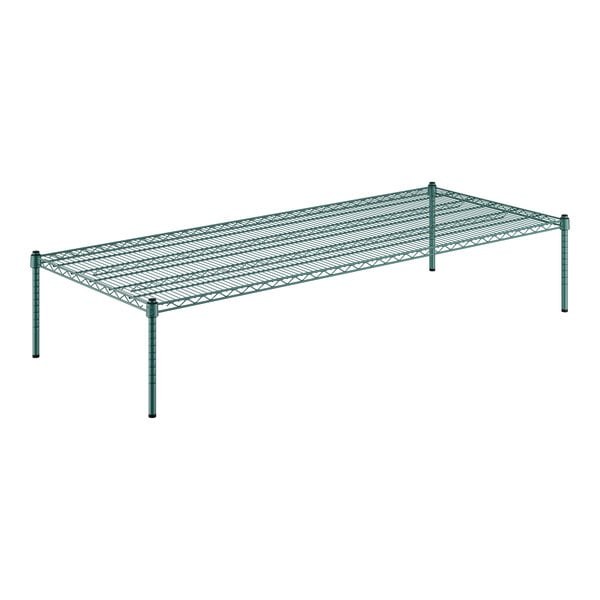 A Regency green wire shelf with 14" posts on a table.