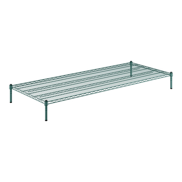 A Regency green wire shelf kit with black legs holding two green shelves.