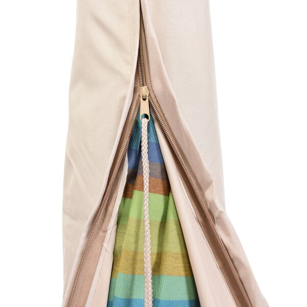 A zippered beige umbrella cover with a close-up of a zipper.