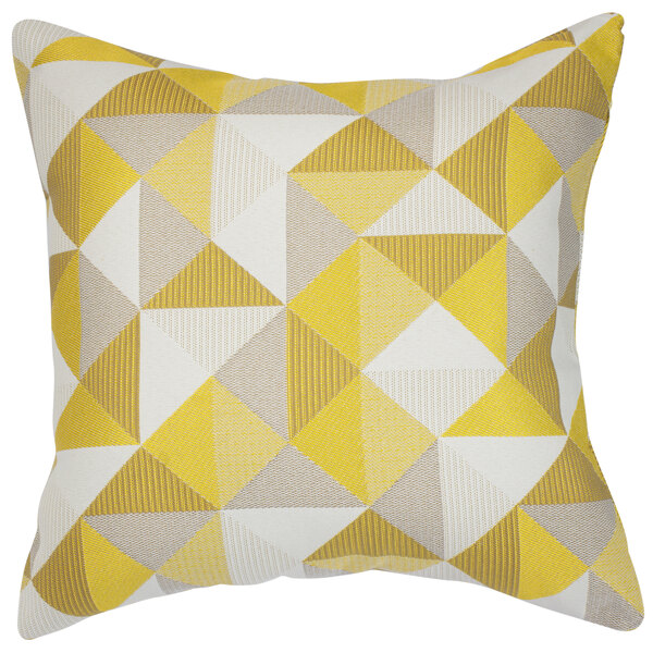 A white throw pillow with a yellow and grey geometric pattern.