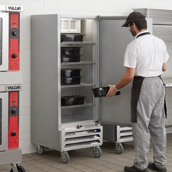 A man opening a Beverage-Air Vista reach-in freezer.