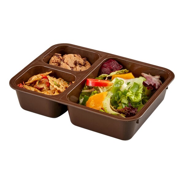 A brown, three-compartment food tray containing salad, pasta, and cookies.