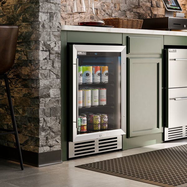 A stainless steel and glass door beverage cooler built into a kitchen or bar counter.
