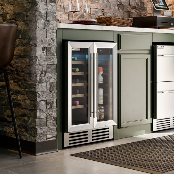 A dual-section, dual-temperature commercial wine cooler with full glass doors built into a kitchen cabinet.